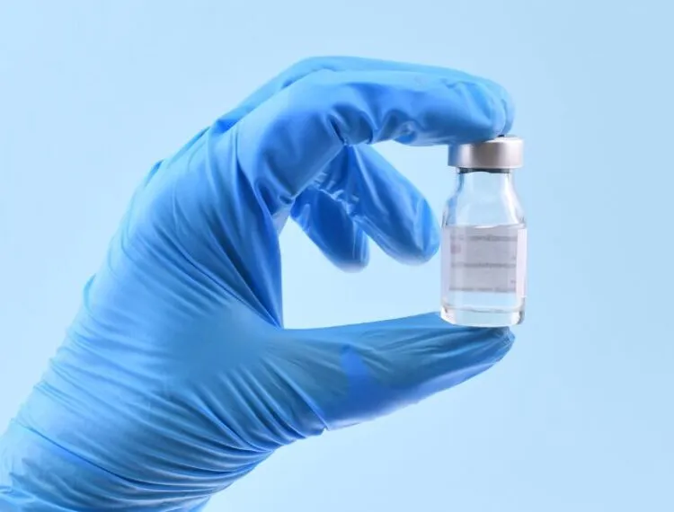 healthcare professional holding treatment vial